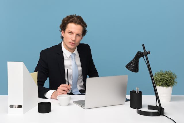 A man sitting at desk and considering finding adhd therapy in chicago